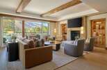 Experience luxury living in this stunning property, featuring a cozy living room with a fireplace and a breathtaking mountain view.