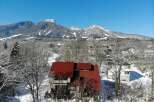Nestled in a serene winter landscape, this property boasts a stunning red-roofed house, offering a cozy retreat.
