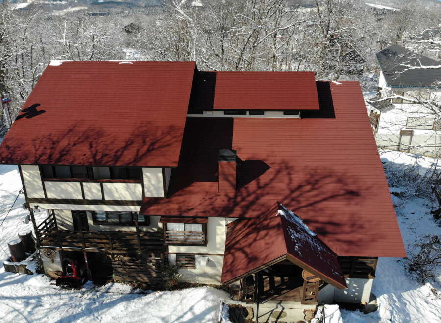 This stunning property boasts a unique architectural design with a striking red roof, perfect for those seeking a distinctive home.