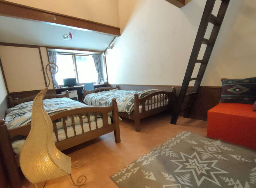 Discover a cozy retreat in this charming bedroom featuring two comfortable beds, perfect for a relaxing stay.