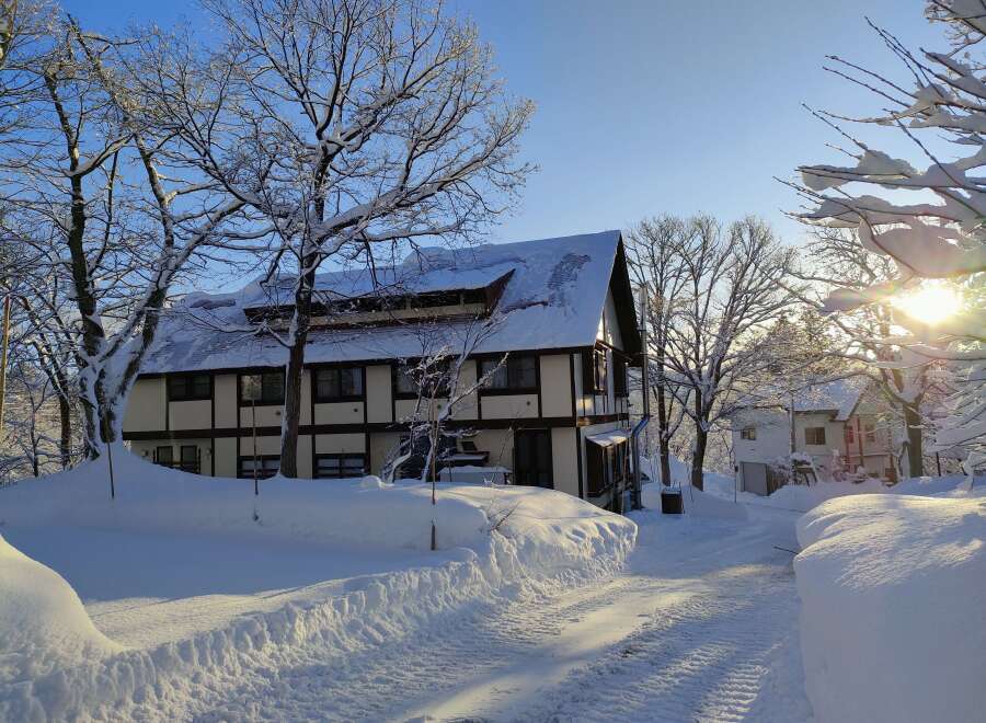 Nestled in a winter wonderland, this charming property boasts a snow-covered roof and a picturesque setting.