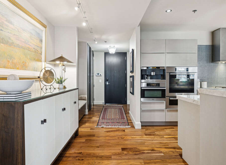Step into luxury with this stunning property featuring a modern kitchen and elegant hardwood floors.