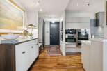 Step into luxury with this stunning property featuring a modern kitchen and elegant hardwood floors.