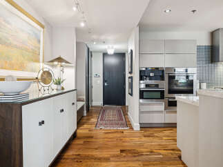 Step into luxury with this stunning property featuring a modern kitchen and elegant hardwood floors.