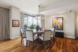 Step into luxury with this stunning dining room, featuring a beautiful round wooden table and elegant patterned chairs.