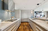 This stunning kitchen boasts a modern design with sleek cabinetry and high-end appliances.