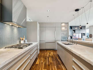 This stunning kitchen boasts a modern design with sleek cabinetry and high-end appliances.