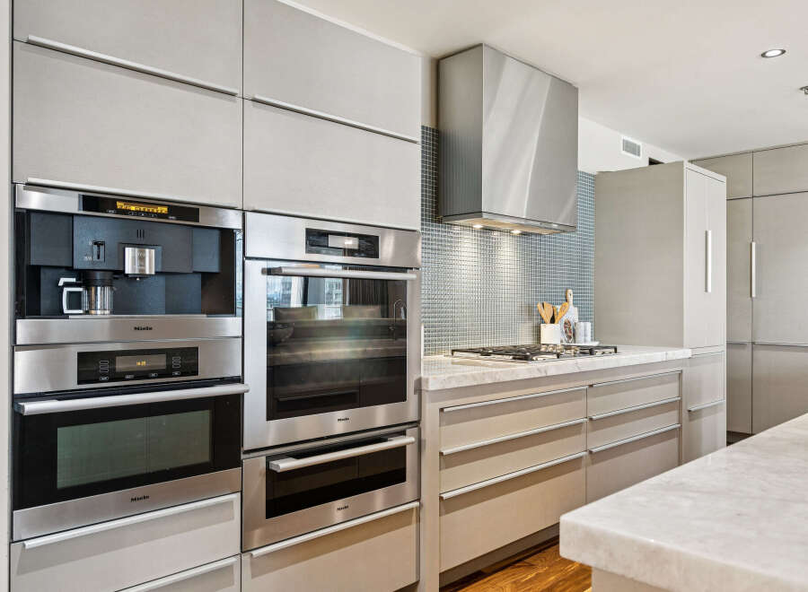 This modern kitchen boasts sleek, high-end appliances and custom cabinetry, perfect for the discerning homeowner.