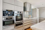 This modern kitchen boasts sleek, high-end appliances and custom cabinetry, perfect for the discerning homeowner.