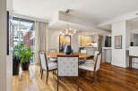 This stunning dining room features a modern design with a round wooden table and stylish chairs.