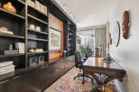 This stunning home office boasts a sophisticated design with custom built-in shelving and a rich, dark wood desk.