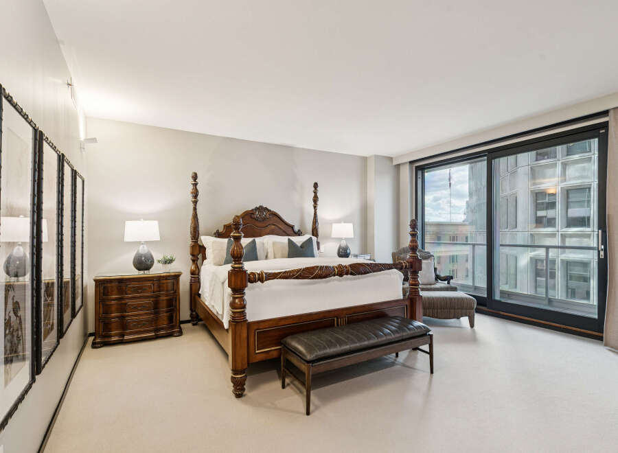 Step into luxury with this stunning bedroom featuring a grand four-poster bed and elegant furnishings.