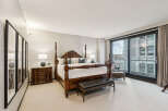 Step into luxury with this stunning bedroom featuring a grand four-poster bed and elegant furnishings.
