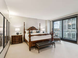 Step into luxury with this stunning bedroom featuring a grand four-poster bed and elegant furnishings.