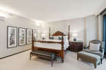 Step into luxury with this exquisite bedroom, featuring a stunning four-poster bed as the centerpiece.