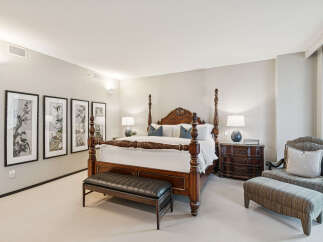 Step into luxury with this exquisite bedroom, featuring a stunning four-poster bed as the centerpiece.