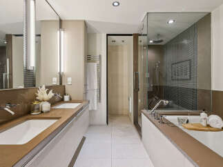 Step into luxury with this stunning bathroom featuring a sleek design and modern amenities.