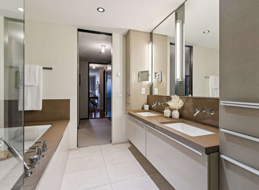 Step into luxury with this stunning bathroom, featuring a sleek design and modern amenities.