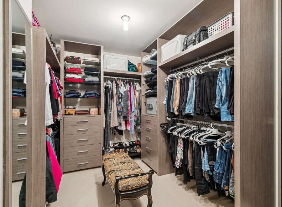 Step into luxury with this meticulously designed walk-in closet, offering ample storage and organization.