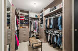 Step into luxury with this meticulously designed walk-in closet, offering ample storage and organization.