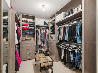 Step into luxury with this meticulously designed walk-in closet, offering ample storage and organization.