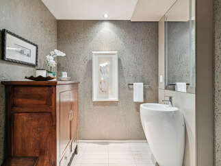 This stunning bathroom boasts a modern design with a touch of elegance.