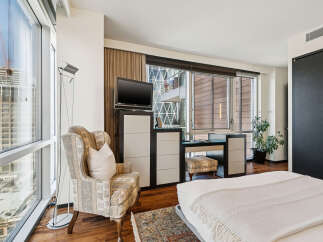 Experience luxury living in this stunning property, featuring expansive windows that flood the space with natural light and offer breathtaking city views.
