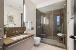 Step into luxury with this stunning bathroom, featuring a sleek glass shower and modern fixtures.