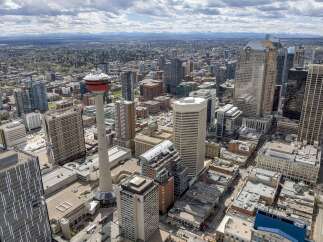 Experience the vibrant energy of downtown Calgary from above! This stunning aerial view showcases a modern cityscape with impressive skyscrapers, including the iconic Calgary Tower.