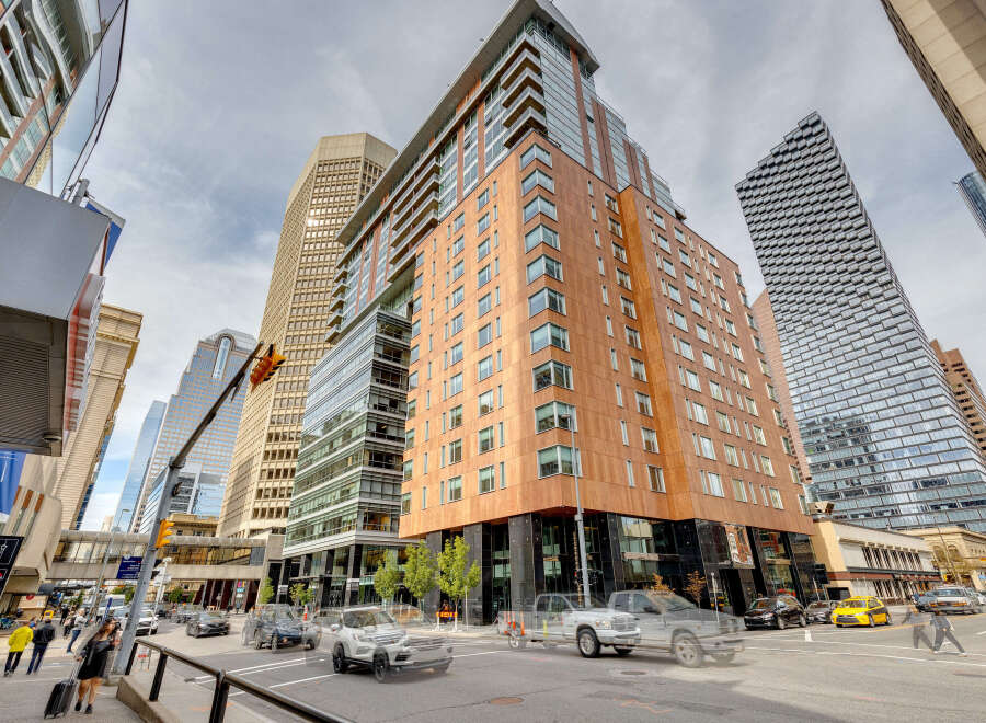 This stunning urban property boasts a modern architectural design with a blend of glass and wood facade.