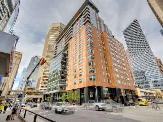 This stunning urban property boasts a modern architectural design with a blend of glass and wood facade.