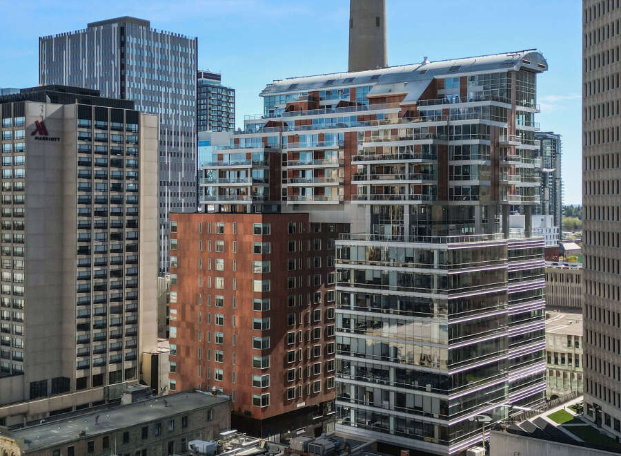 Discover modern urban living in this stunning high-rise apartment complex, featuring sleek architecture and expansive glass balconies offering breathtaking city views.