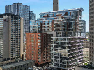 Discover modern urban living in this stunning high-rise apartment complex, featuring sleek architecture and expansive glass balconies offering breathtaking city views.