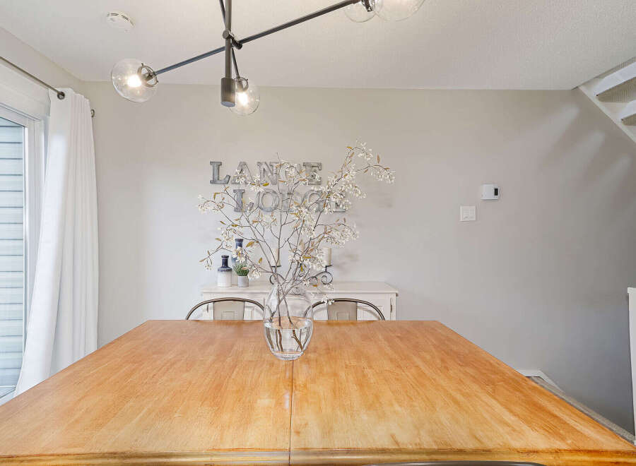 This stunning dining room features a beautiful wooden table, perfect for hosting gatherings.
