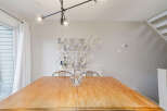 This stunning dining room features a beautiful wooden table, perfect for hosting gatherings.