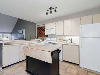 This charming kitchen boasts a functional layout with ample counter space and storage.