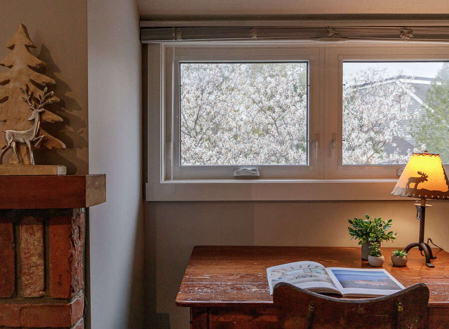 This cozy space features a charming desk area with a view.