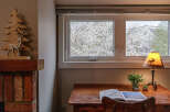 This cozy space features a charming desk area with a view.