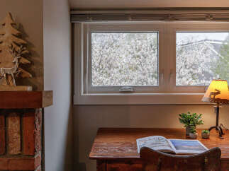 This cozy space features a charming desk area with a view.