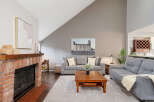 Discover the charm of this inviting living space, featuring a cozy fireplace and a stylish seating area.