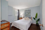 This cozy bedroom features a comfortable bed with stylish bedding, perfect for a relaxing retreat.