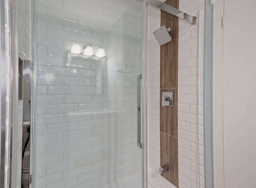 Step into luxury with this stunning bathroom featuring a modern glass shower enclosure.
