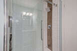 Step into luxury with this stunning bathroom featuring a modern glass shower enclosure.