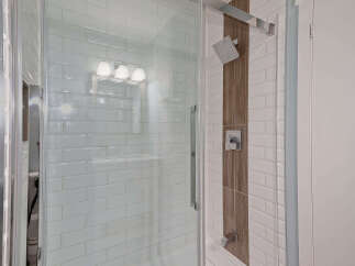 Step into luxury with this stunning bathroom featuring a modern glass shower enclosure.