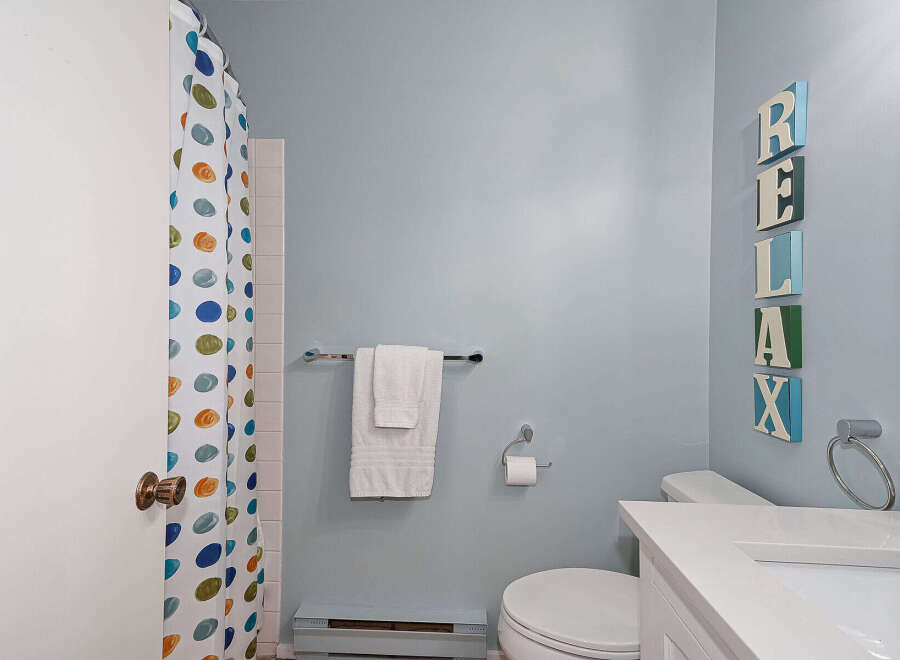 This charming bathroom features a clean and modern design, perfect for a relaxing retreat.