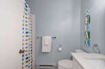 This charming bathroom features a clean and modern design, perfect for a relaxing retreat.