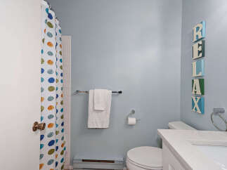 This charming bathroom features a clean and modern design, perfect for a relaxing retreat.