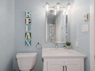 This charming bathroom features a bright and airy design, perfect for relaxation.