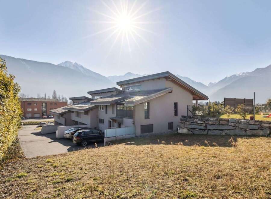 This stunning property boasts modern architecture with a neutral color palette, seamlessly blending with the surrounding natural beauty.