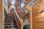 Step into rustic elegance with this stunning wooden staircase.